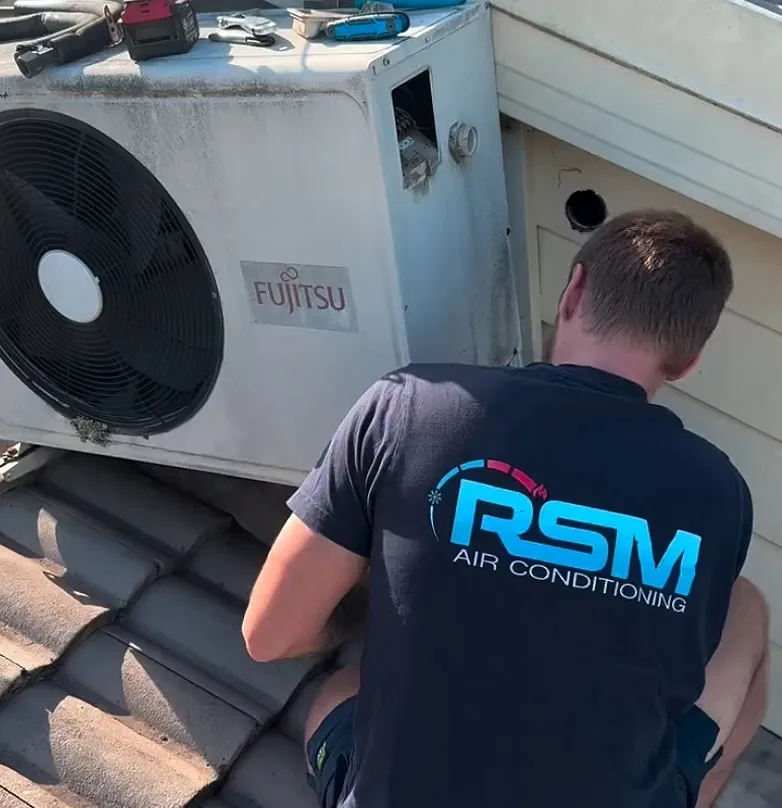 RSM Air Conditioning technician servicing Fujitsu outdoor unit